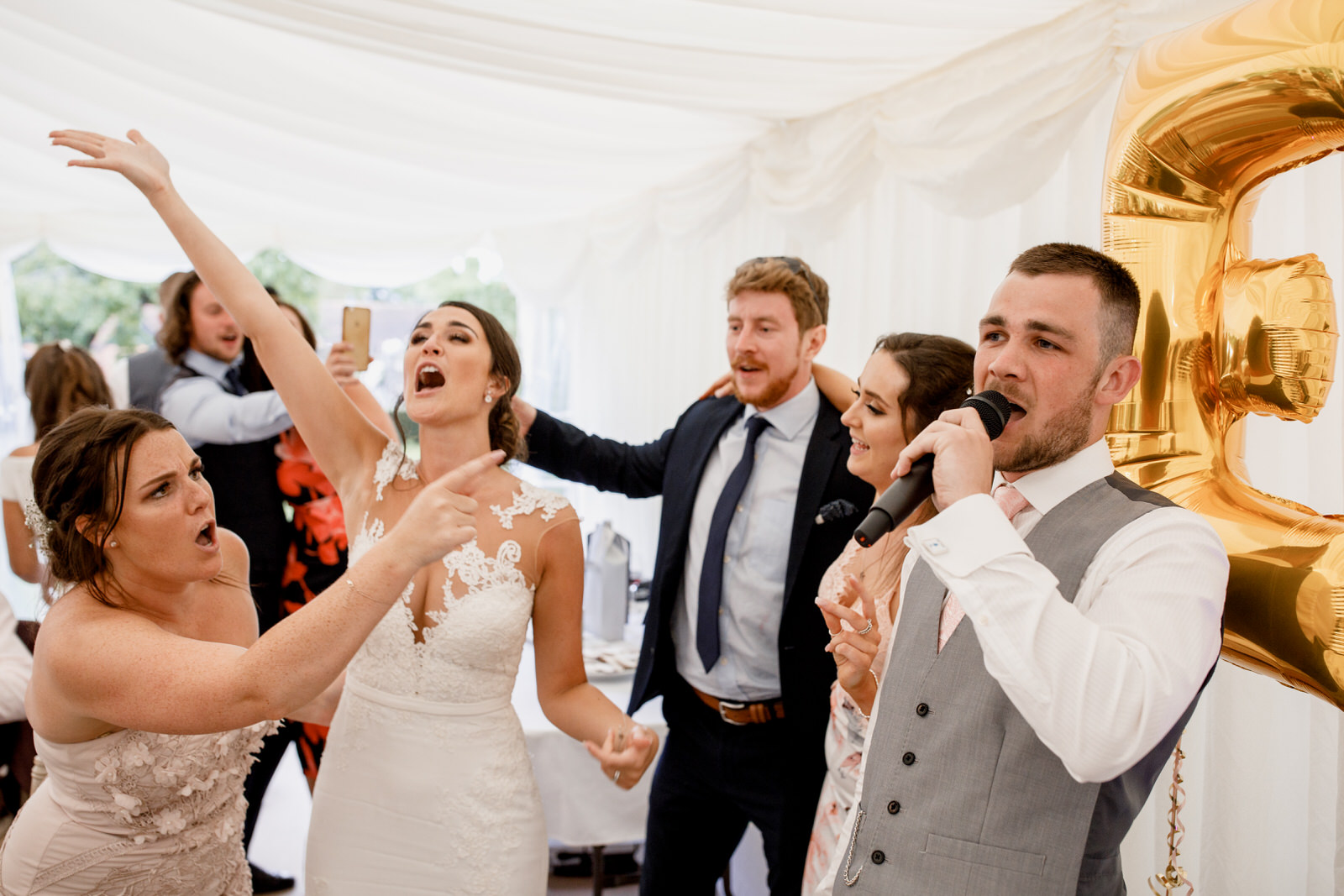 guests singing at sanctum on the green wedding