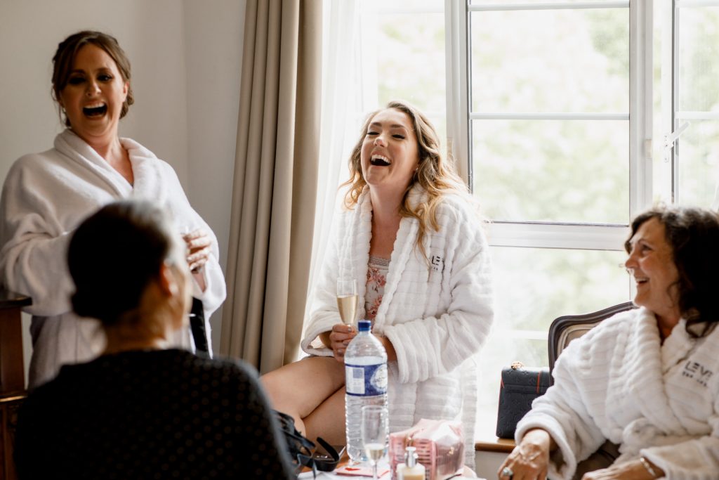 bridesmaid laughing at wedding in window