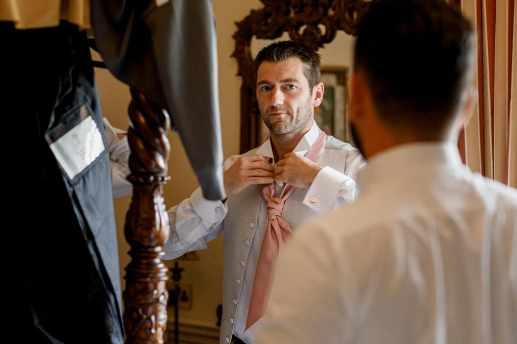 groom doing tie at offley place