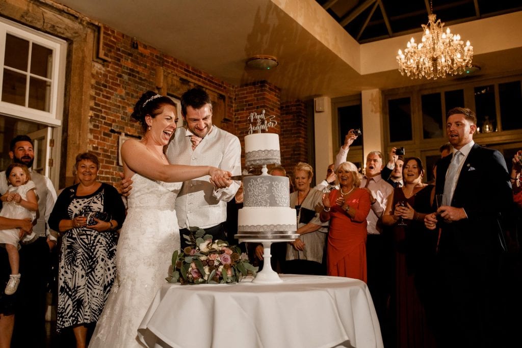 cutting cake at offley place wedding