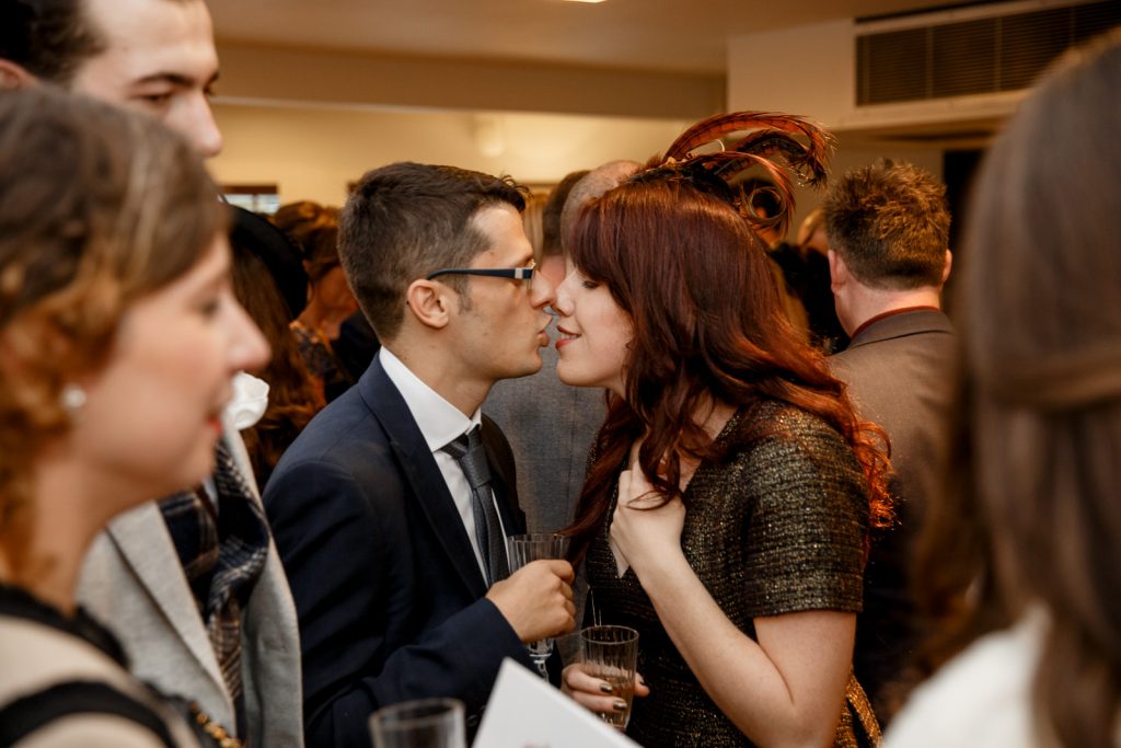 guests kissing at wedding