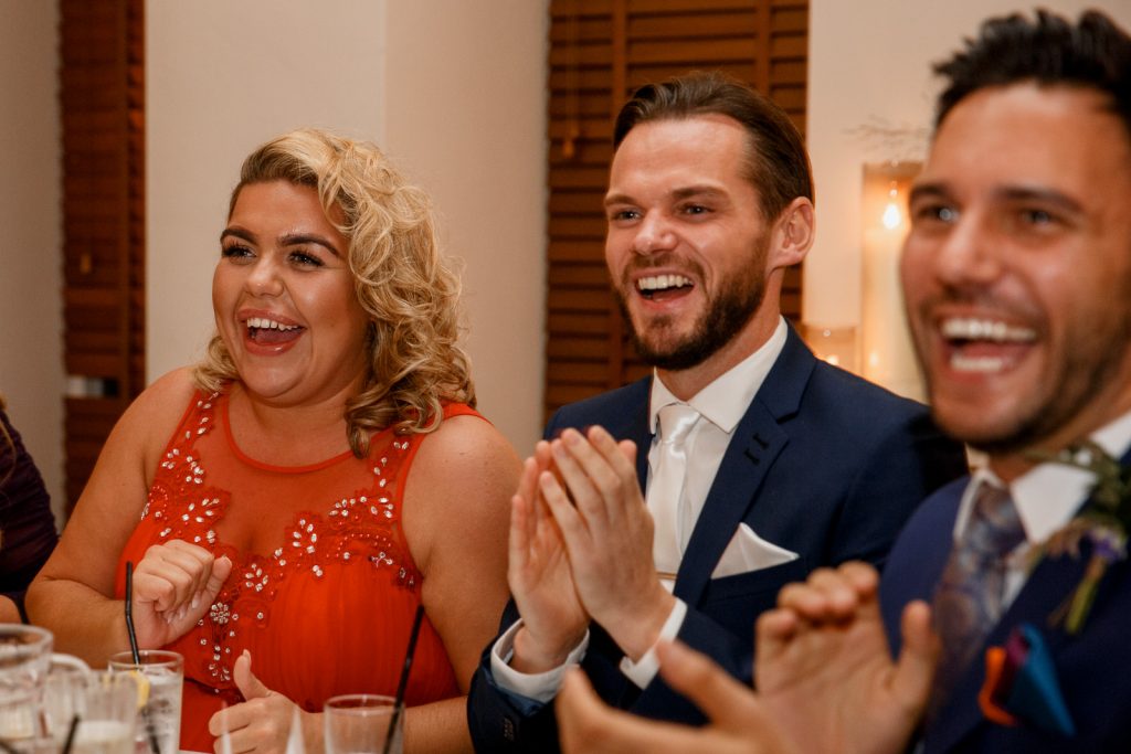 guests laughing at wedding speeches