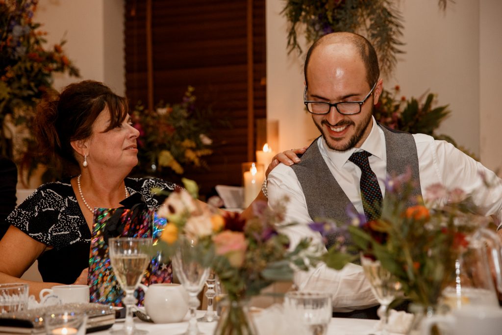 groom laughing with mother
