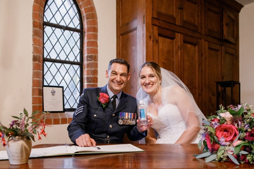 bride and groom with hand sanitiser