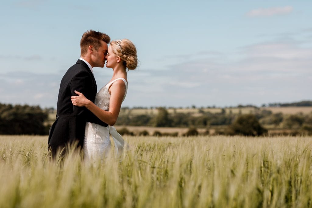 bride and groom in field