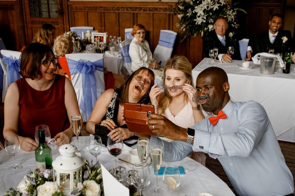 guests taking selfies at wedding