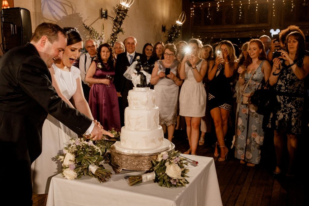 cutting the cake at fanhams hall wedding