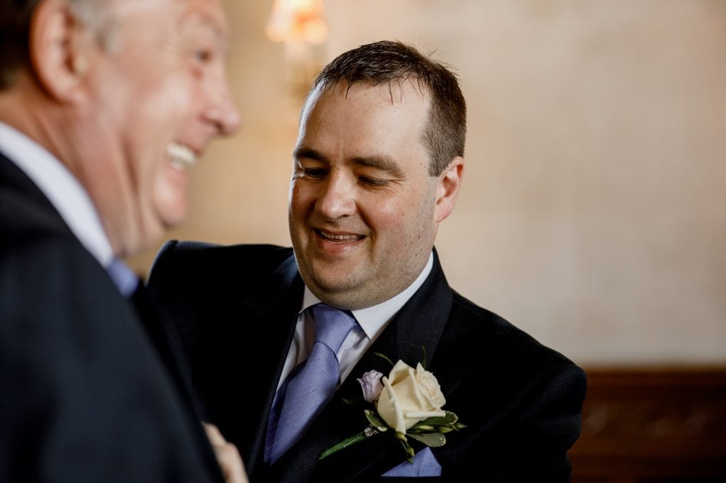 groom and father sorting suits
