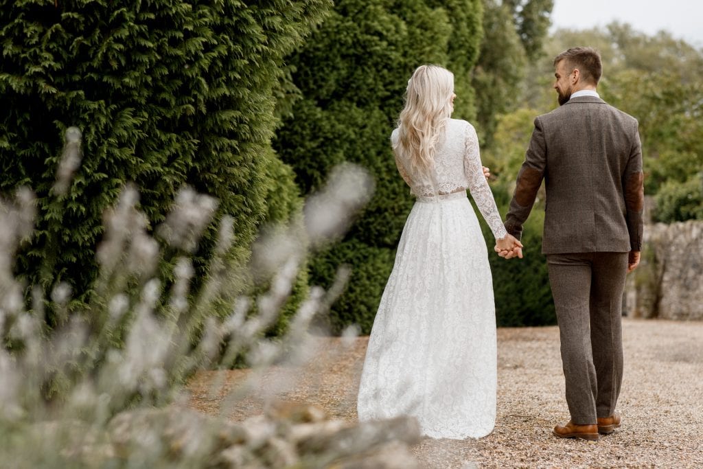 bride and groom walking along pathway