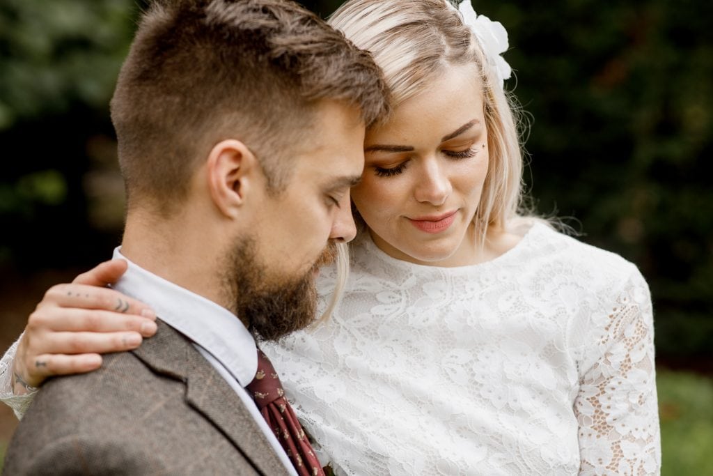 close up image of the bride and groom smiling
