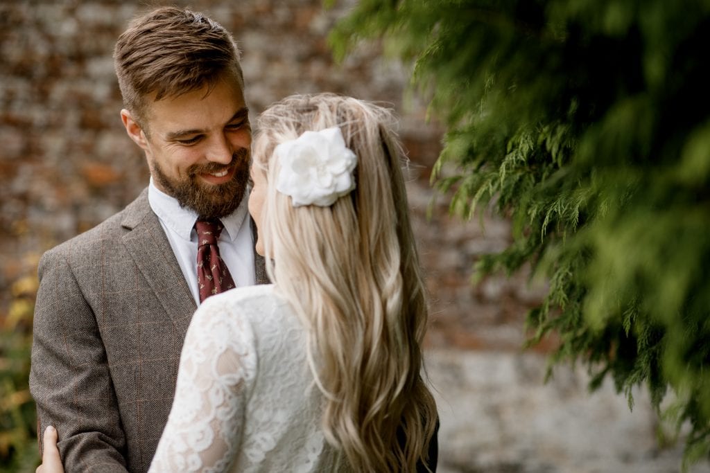 groom looking and smiling at bride