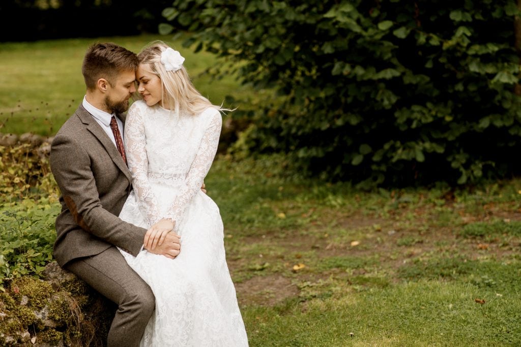 bride sitting on grooms lap