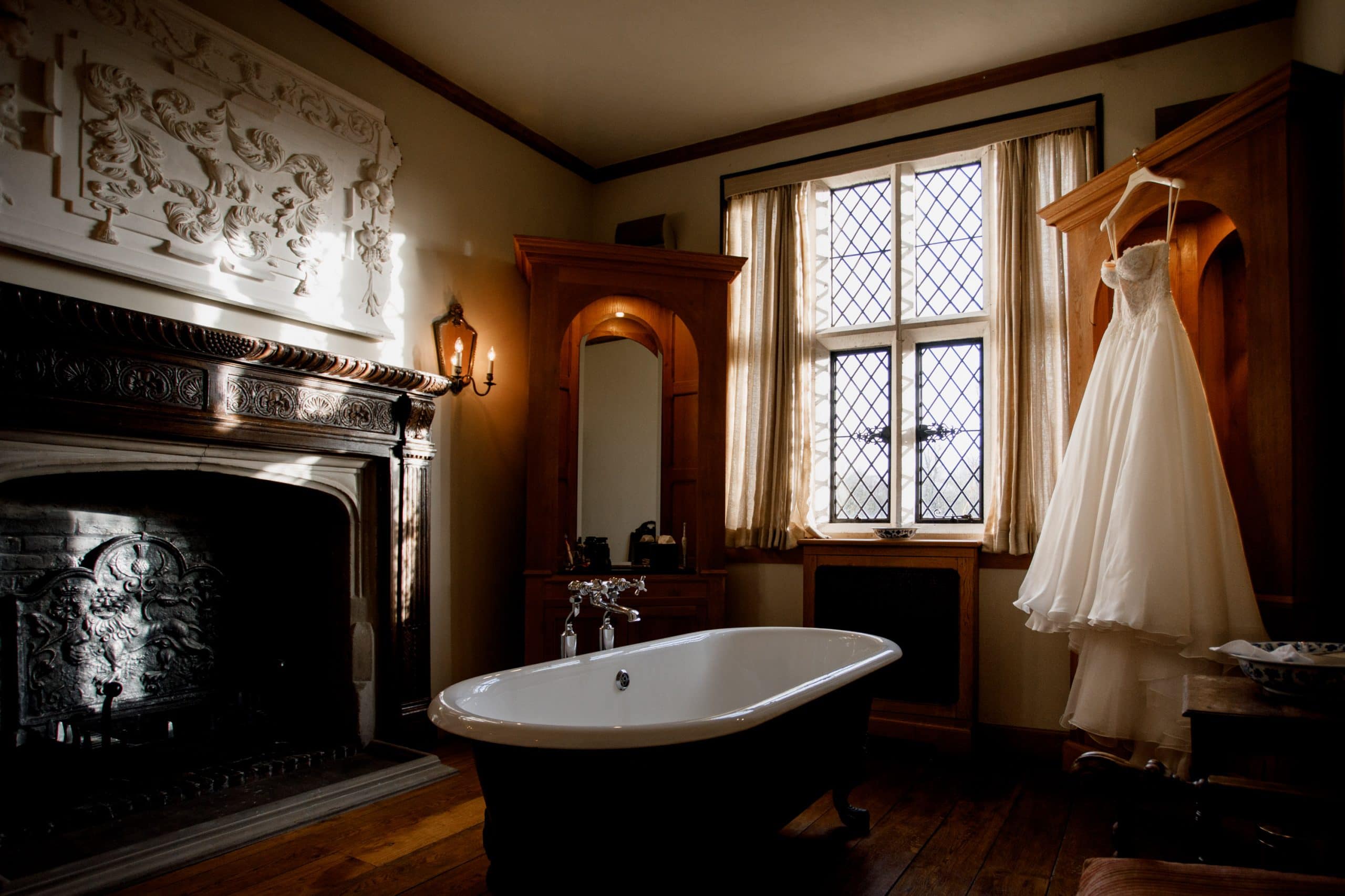 wedding dress hanging in bathroom