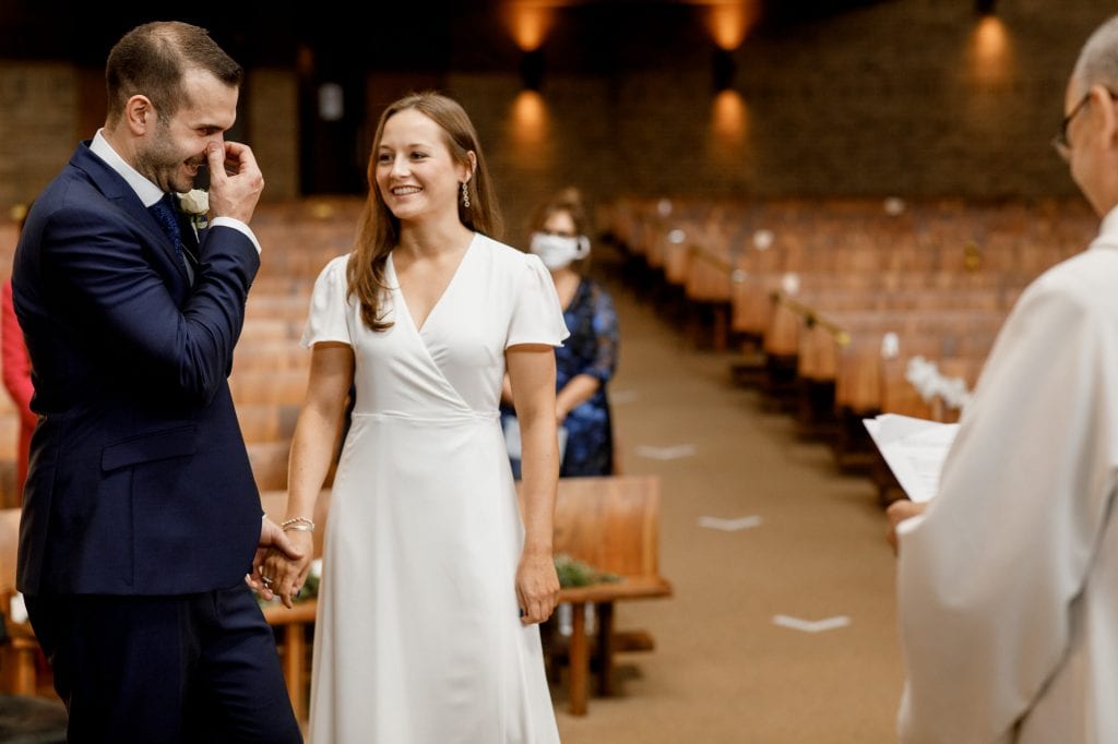 bride and groom laughing at covid secure wedding