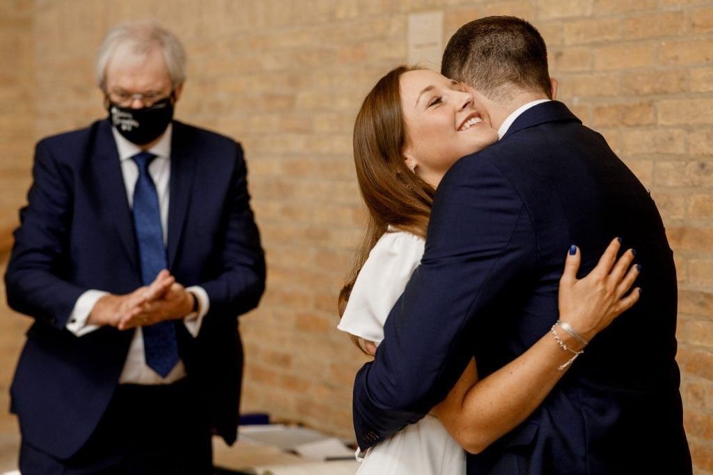 bride and groom hugging at covid wedding