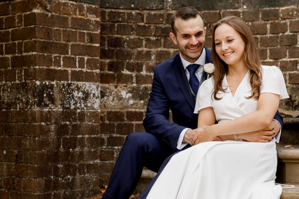 bride and groom on steps holding hands