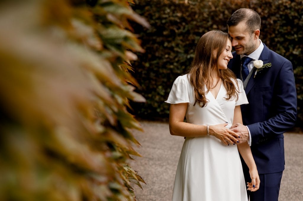 bridal portrait against green bush