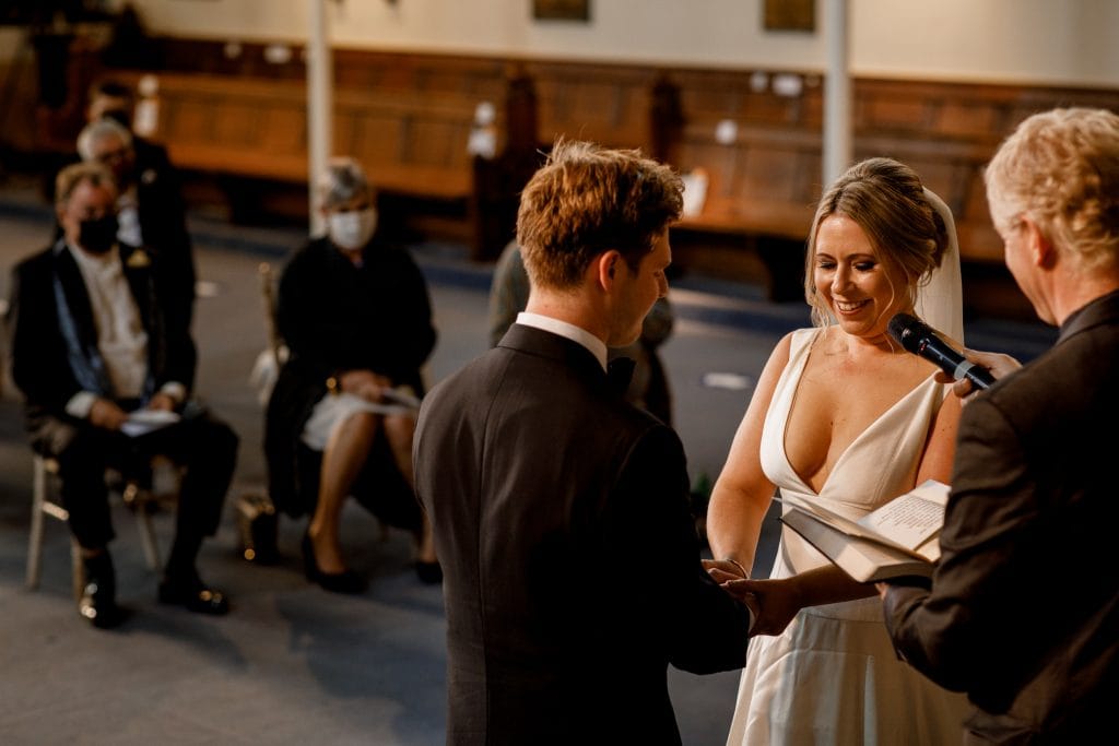 bride smiling at vows