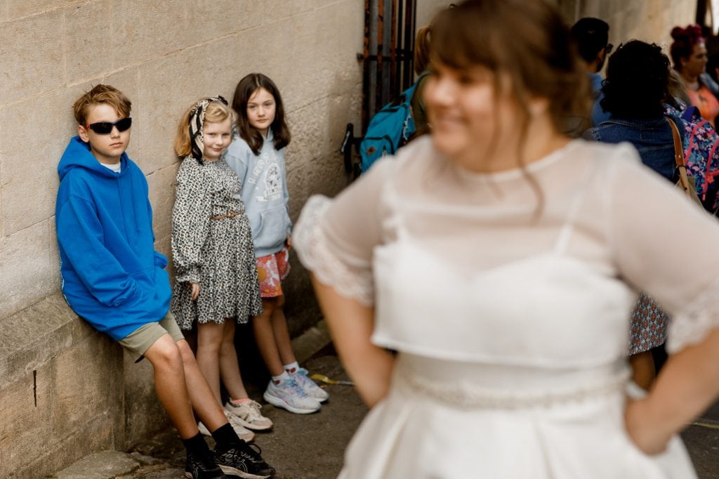 boy looking at bride with sunglasses